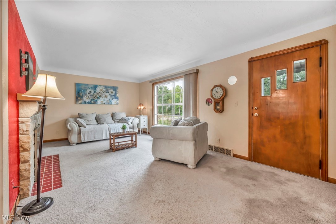 455 East Sprague Road Independence, OH 44131 - Photo 6 of 39 Carpeted living room with a stone fireplace