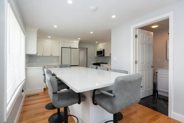 a large kitchen with a table and chairs