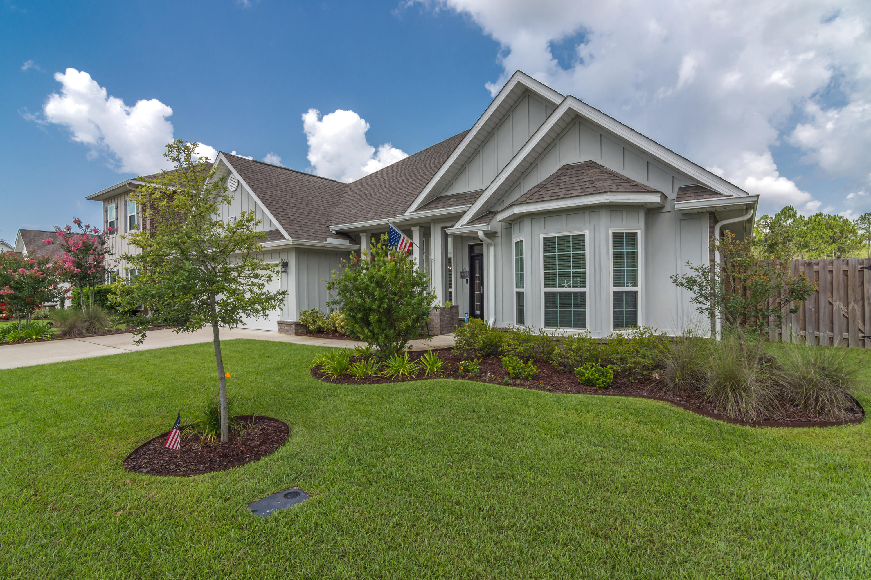 341 Lilly Bell Lane Freeport, FL 32439 - Photo 2 of 36 a front view of a house with a yard