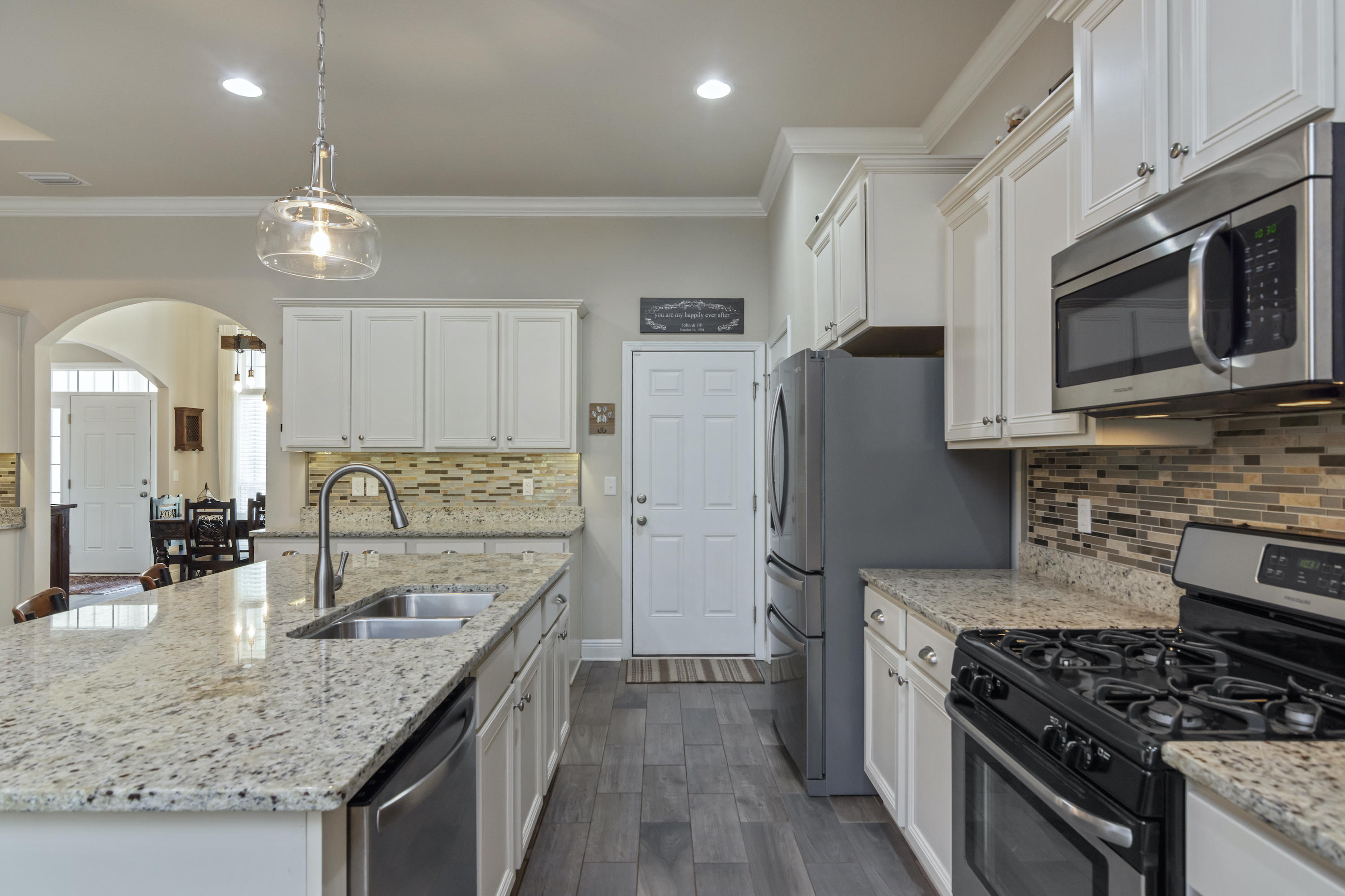 341 Lilly Bell Lane Freeport, FL 32439 - Photo 14 of 36 a kitchen with stainless steel appliances granite countertop a sink stove and refrigerator