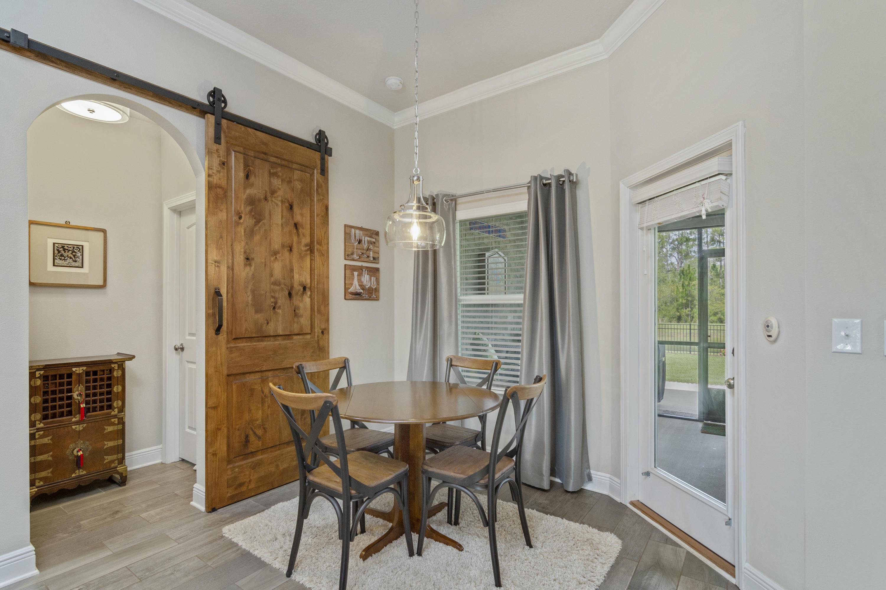 341 Lilly Bell Lane Freeport, FL 32439 - Photo 15 of 36 a view of a dining room with furniture and a window