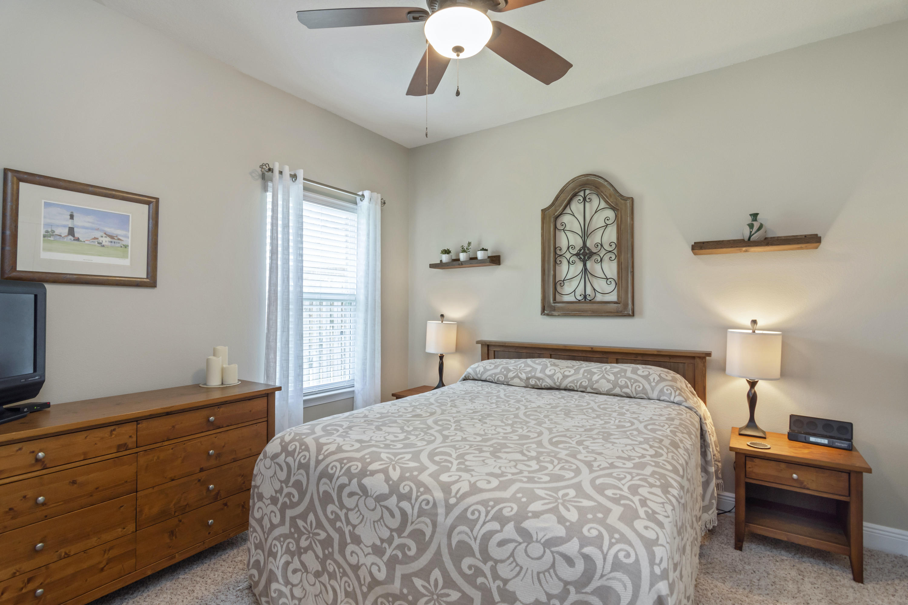 341 Lilly Bell Lane Freeport, FL 32439 - Photo 23 of 36 a bedroom with a bed and a chandelier