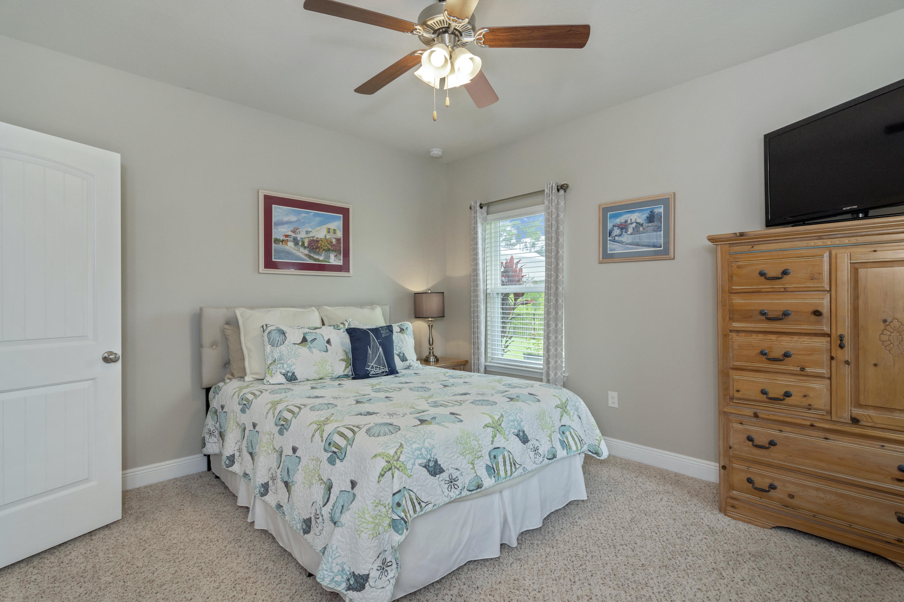 341 Lilly Bell Lane Freeport, FL 32439 - Photo 26 of 36 a bedroom with a bed and a tv