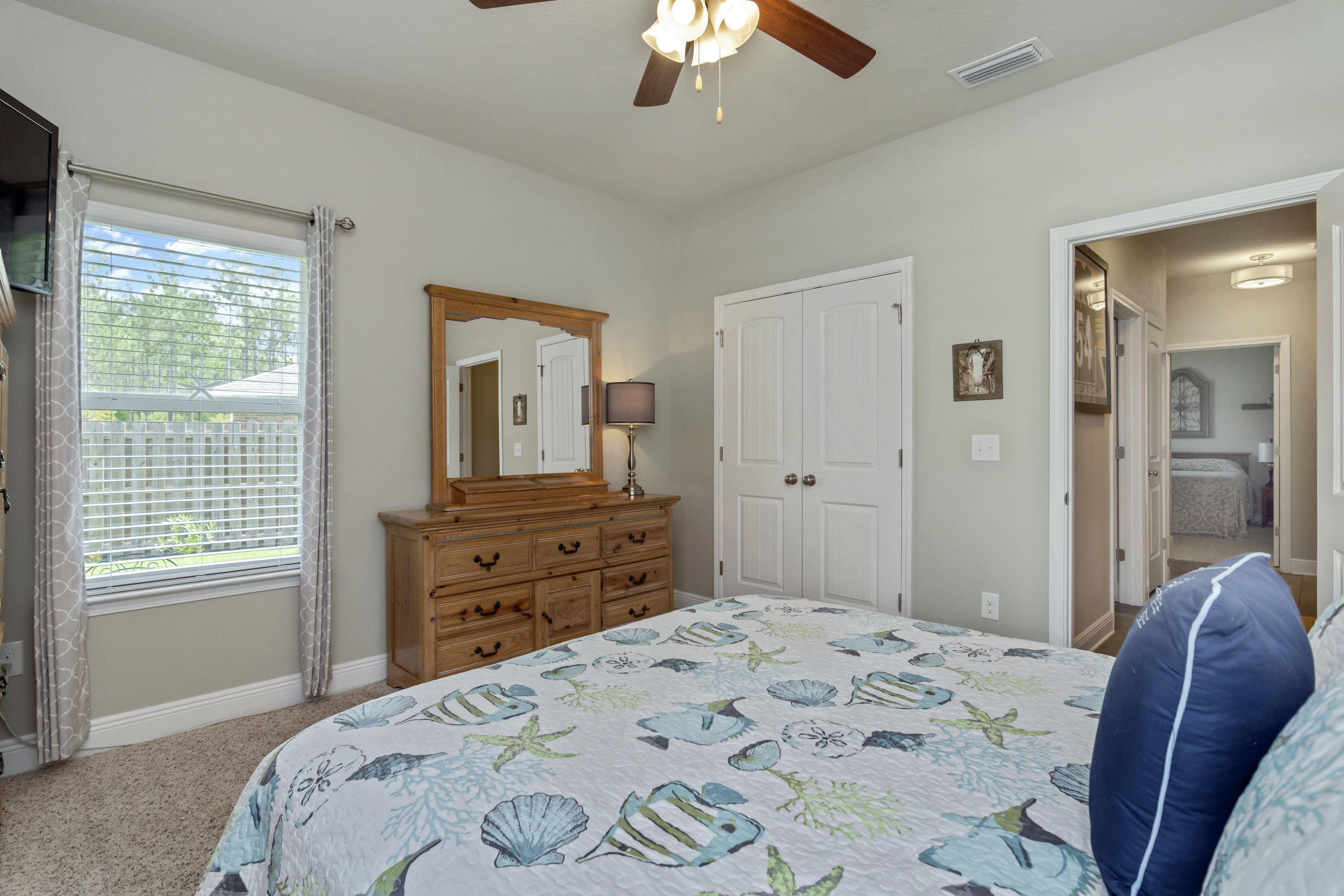 341 Lilly Bell Lane Freeport, FL 32439 - Photo 27 of 36 a bedroom with a bed and a dresser