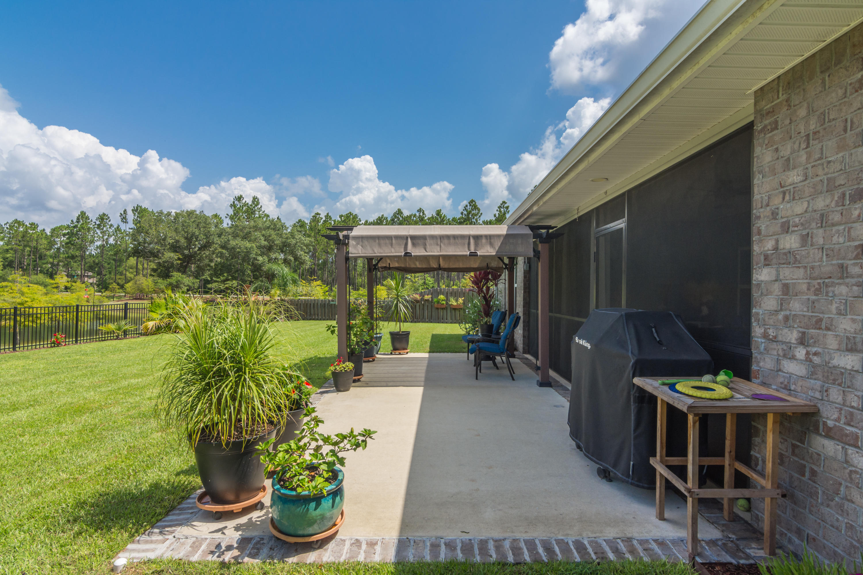 341 Lilly Bell Lane Freeport, FL 32439 - Photo 30 of 36 a patio with table and chairs