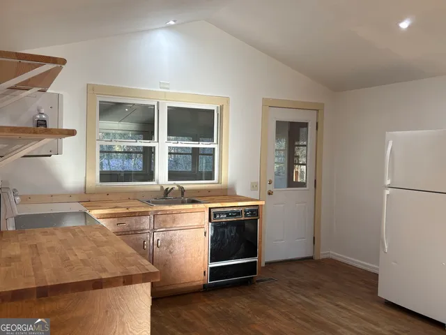 a kitchen with stainless steel appliances granite countertop a stove and a refrigerator