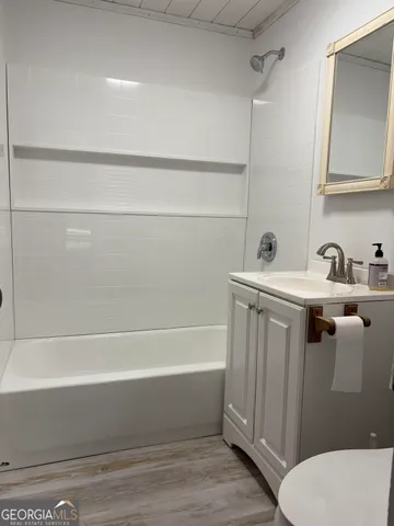 a bathroom with a sink a toilet and bathtub