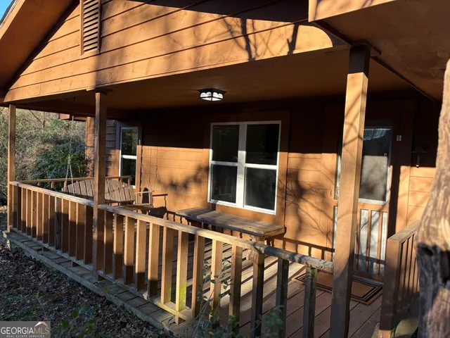 a view of balcony with two chairs and a barbeque