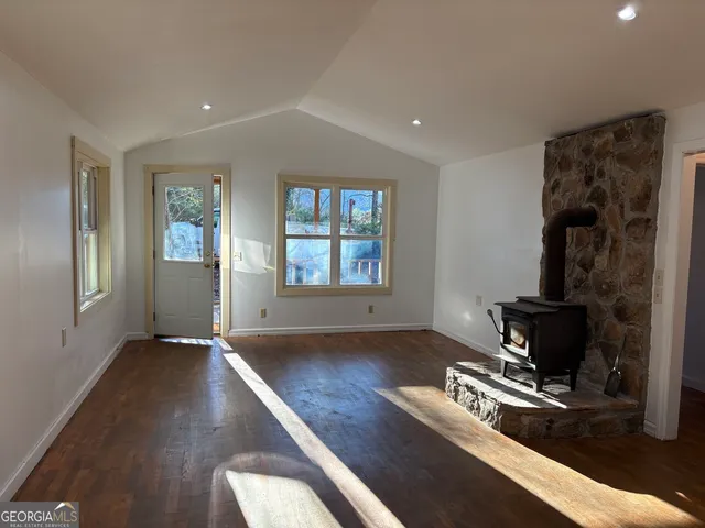 a living room with furniture fireplace and window