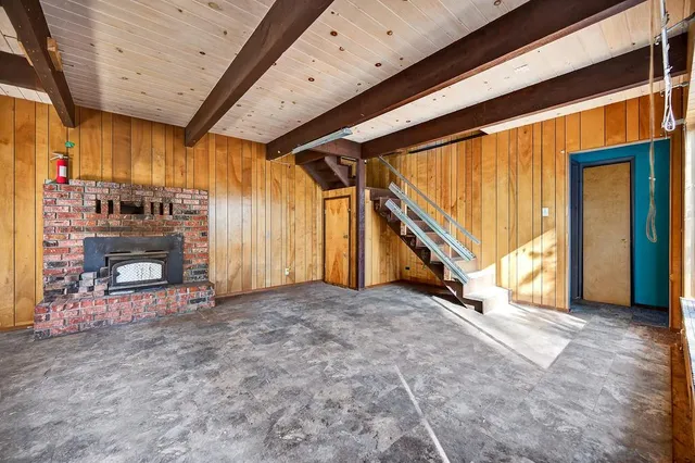 a view of an empty room with a fireplace