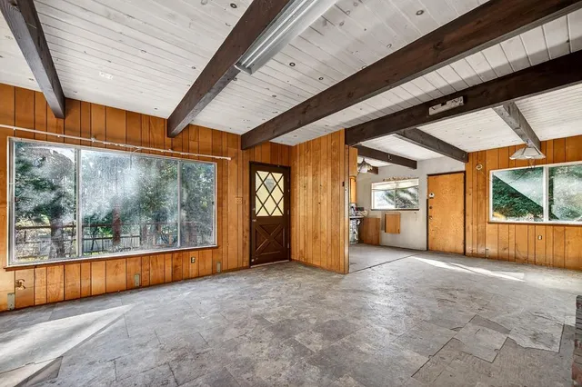 a view of a kitchen with a sink and dishwasher a refrigerator with white cabinets