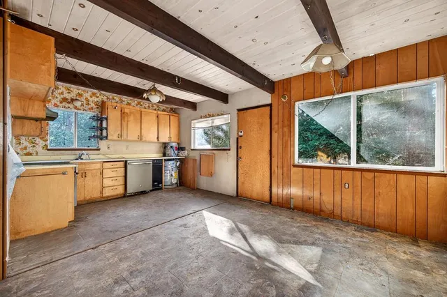 a view of a kitchen with a sink and cabinets
