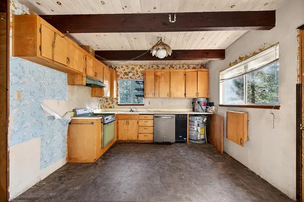 a kitchen with a sink window and cabinets