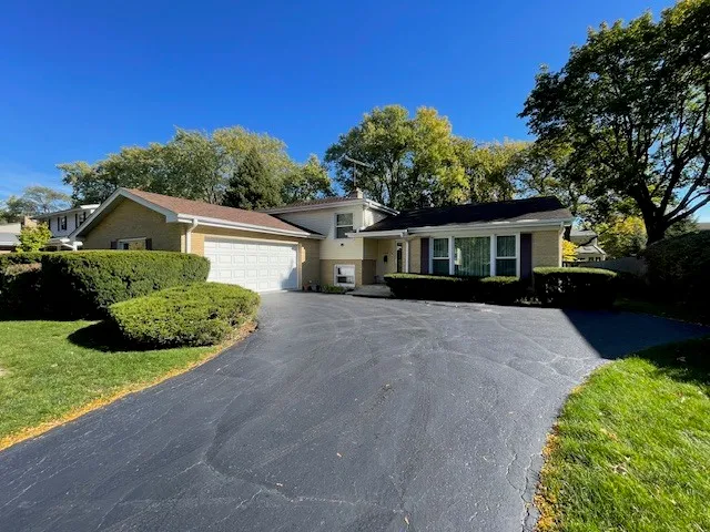 a view of a house with a yard and potted plants
