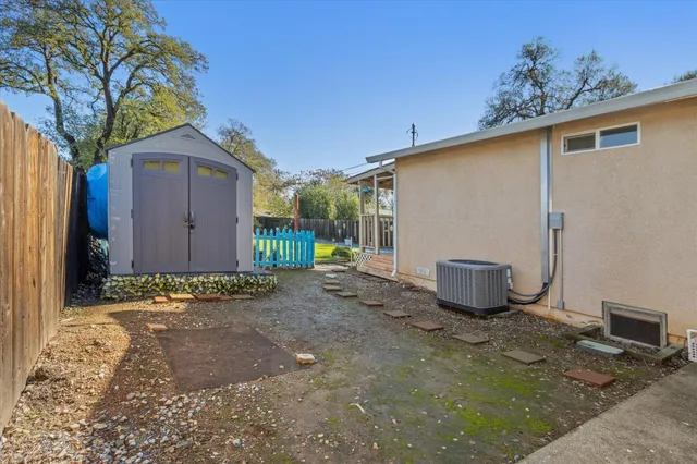 a view of a house with backyard and sitting area