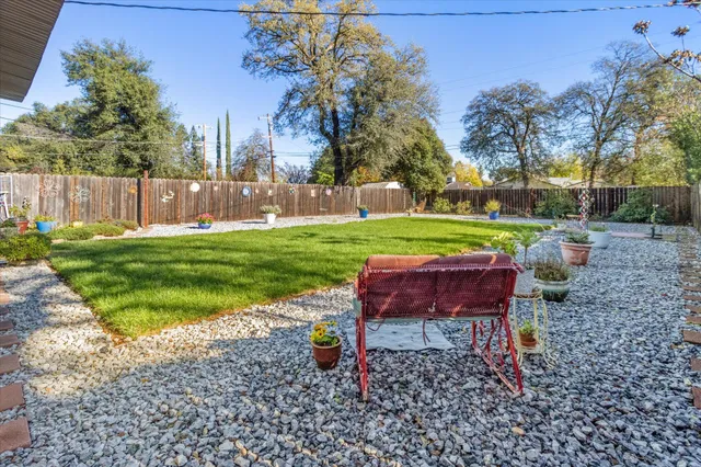 a backyard of a house with table and chairs