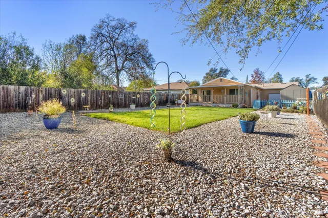 a view of a swimming pool with a patio and a yard