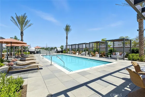 a view of swimming pool with outdoor seating and a terrace