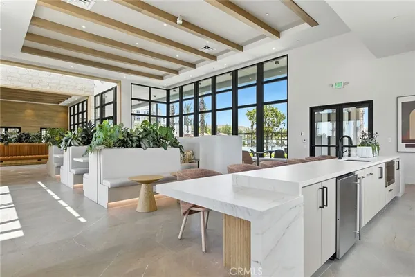 a large white kitchen with a large window
