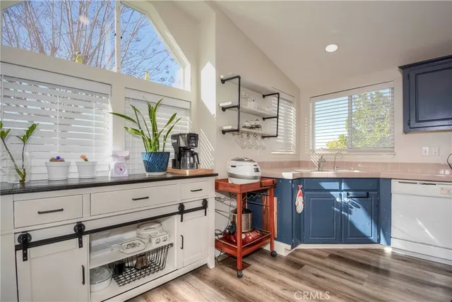 a kitchen with a sink cabinets and window