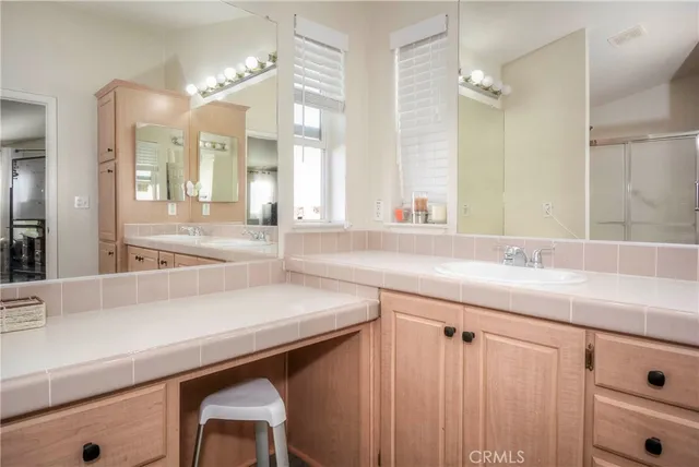a bathroom with a shower sink and mirror