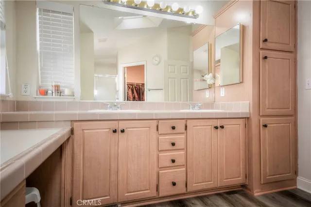 a view of a bathroom with a sink a mirror and a shower