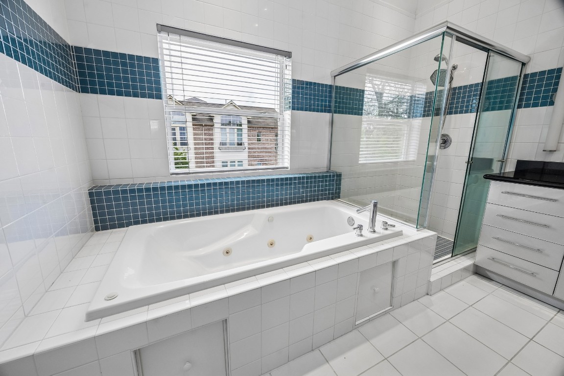 1820 Prospect Street Houston, TX 77004 - Photo 13 of 17 a bathroom with a bathtub and a shower