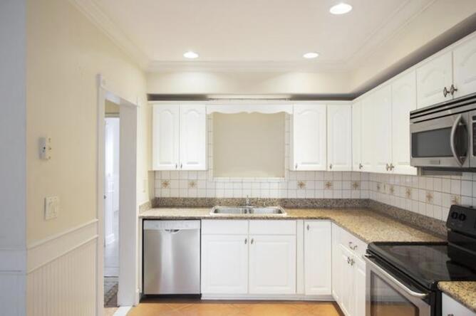 2311 Patterson Avenue Key West, FL 33040 - Photo 38 of 39 a kitchen with granite countertop white cabinets and white appliances