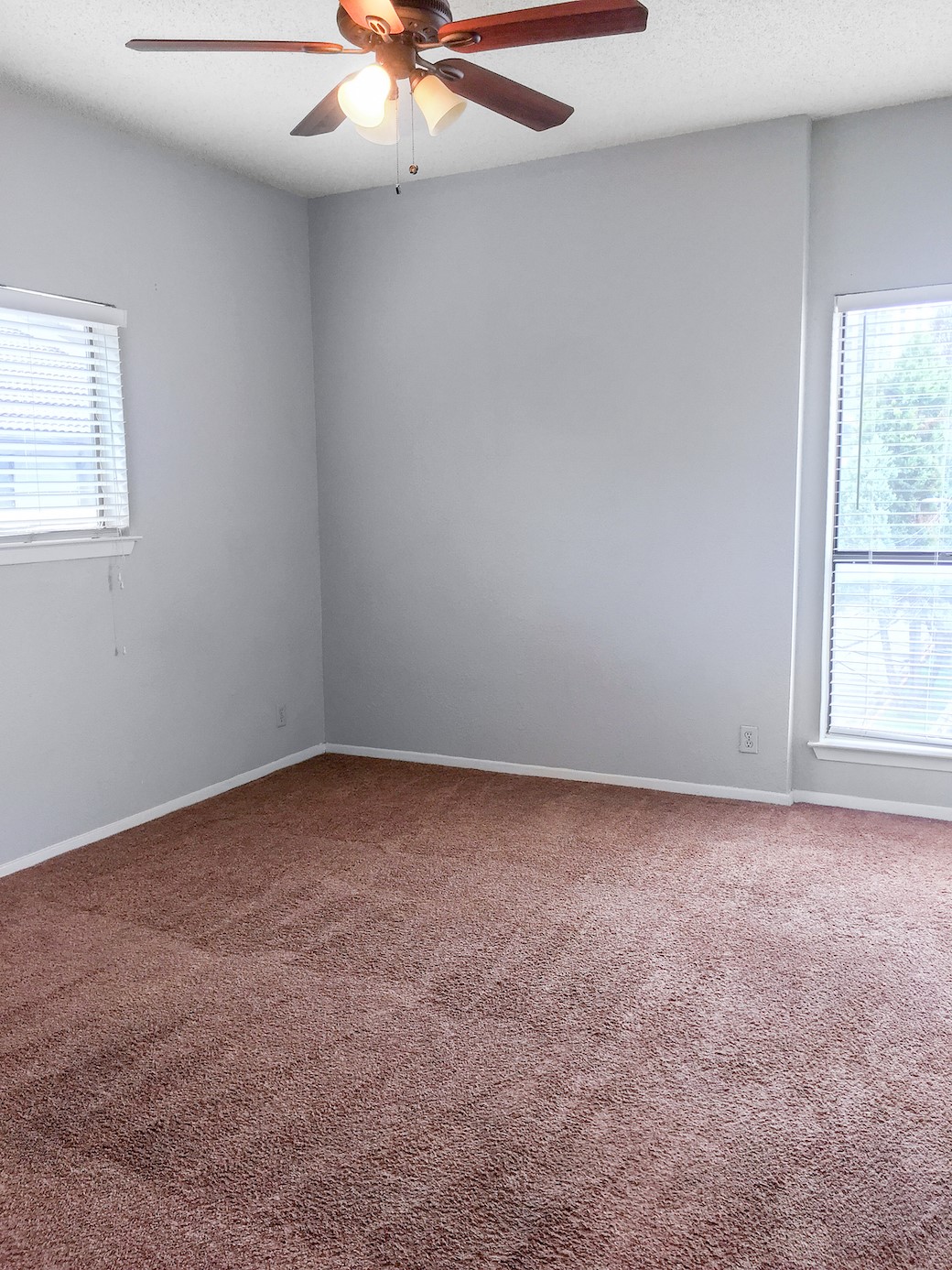 807 West 25th Street, Unit 312 Austin, TX 78705 - Photo 12 of 15 Empty room featuring ceiling fan, dark carpet, and a textured ceiling
