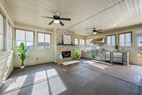 a living room with furniture a fireplace and a chandelier