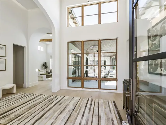 a view of a living room and a balcony with wooden floor