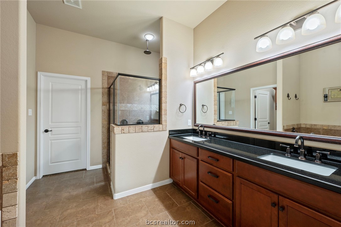 3085 Archer Circle Bryan, TX 77808 - Photo 16 of 32 Full bathroom with double vanity and a separate shower.