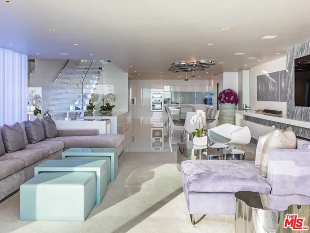 a living room with furniture and kitchen view