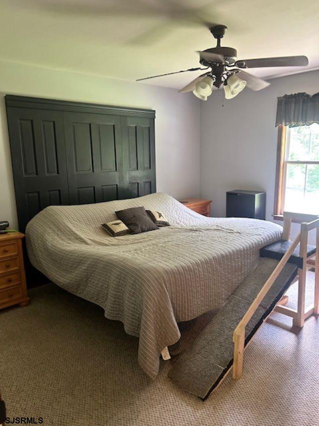 120 Head Of River Road Corbin City, NJ 08270 - Photo 13 of 19 a bedroom with a bed and a chandelier