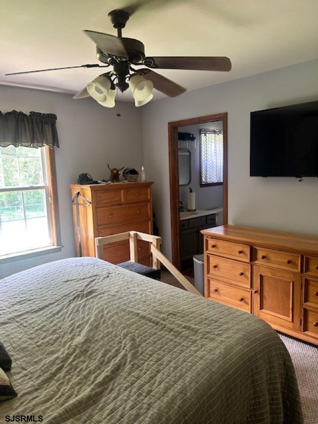 120 Head Of River Road Corbin City, NJ 08270 - Photo 14 of 19 a bedroom with a bed and a flat screen tv