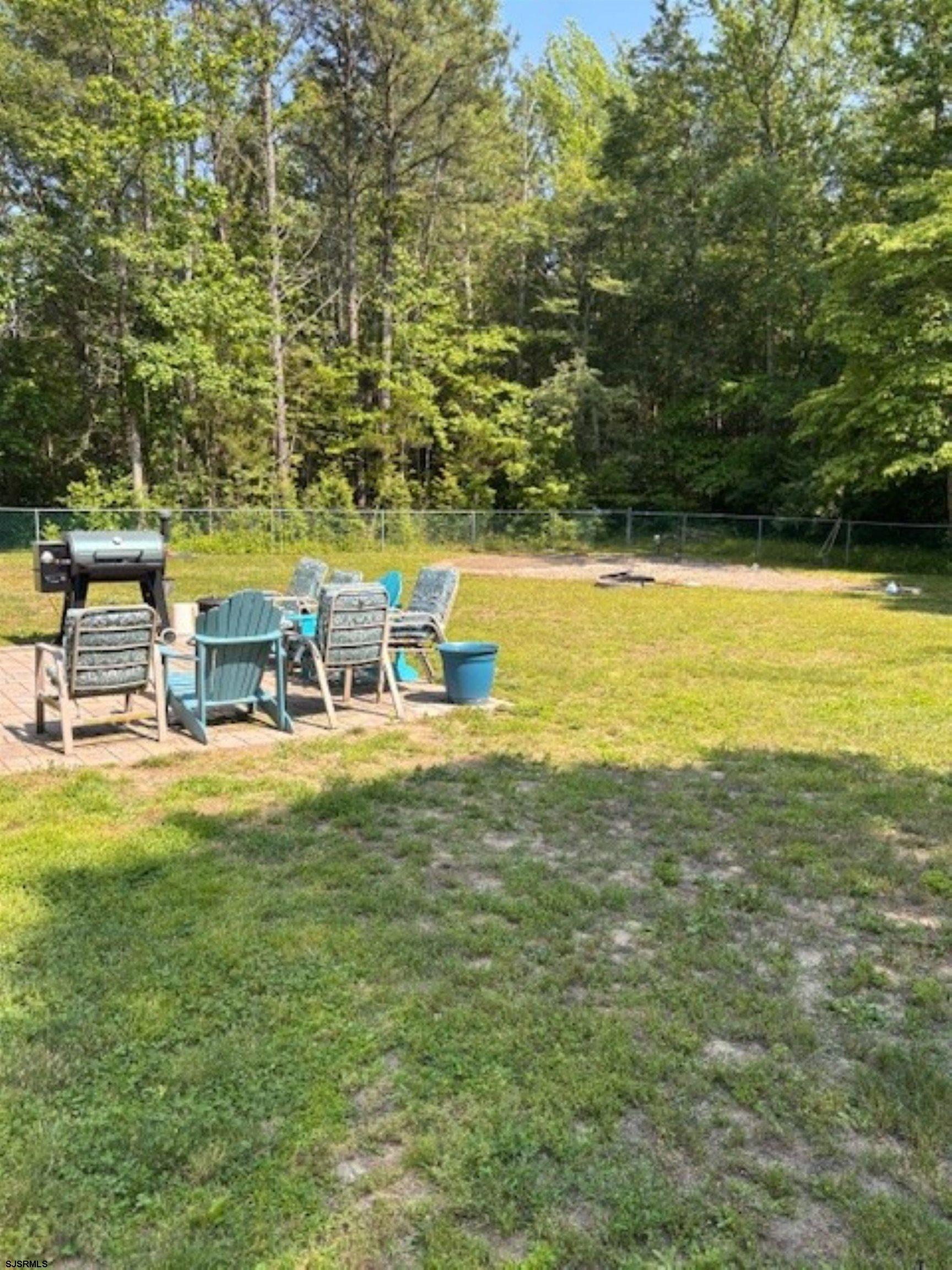120 Head Of River Road Corbin City, NJ 08270 - Photo 19 of 19 a view of a swimming pool with lawn chairs under an umbrella