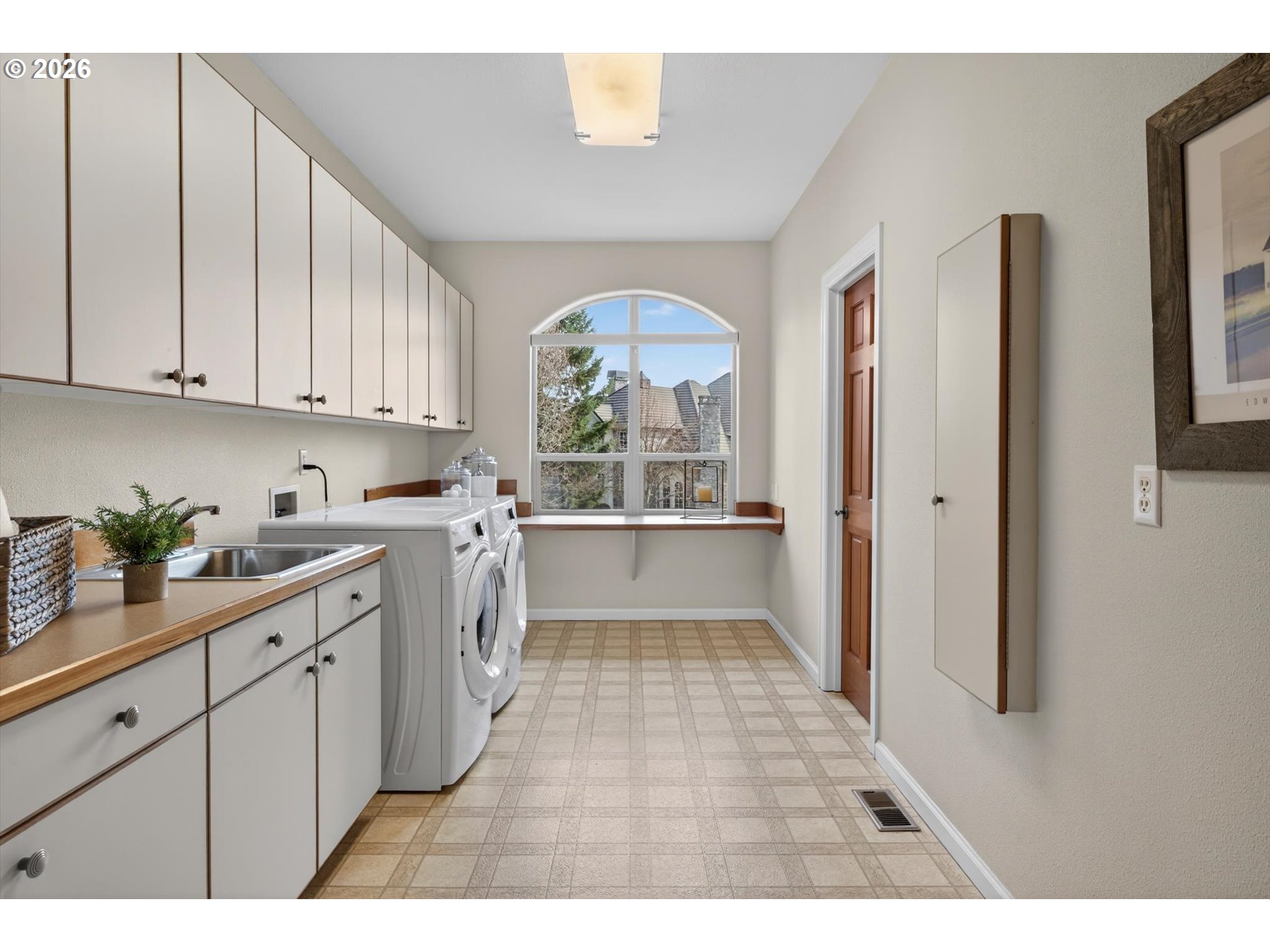 3390 Quail Ridge Court West Linn, OR 97068 - Photo 22 of 48 a kitchen with a white cabinets and wooden floor
