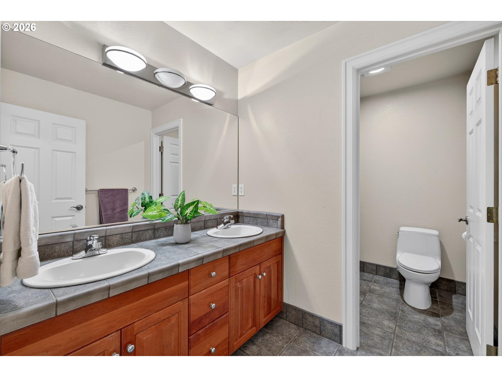 3390 Quail Ridge Court West Linn, OR 97068 - Photo 32 of 48 a bathroom with a granite countertop sink a toilet and a mirror