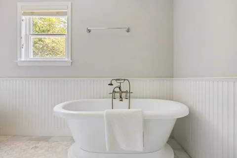 a bathroom with a granite countertop toilet a sink and a mirror
