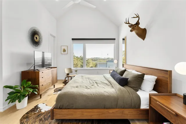 a bedroom with a bed and a chandelier