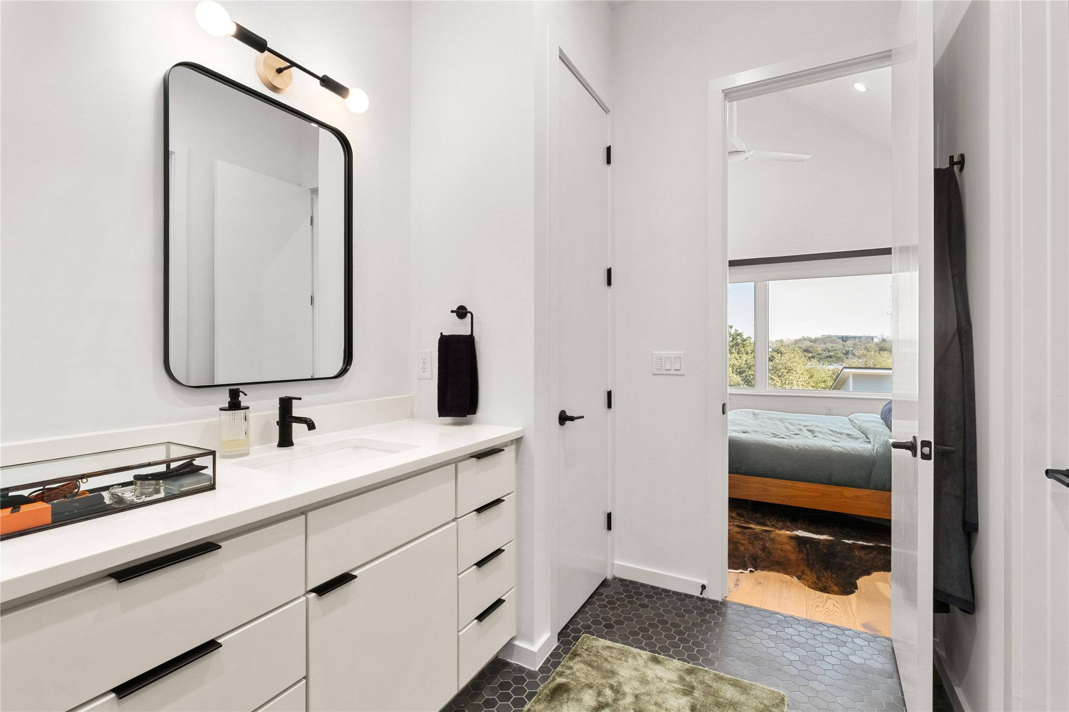 410 West Alpine Road, Unit 10 Austin, TX 78704 - Photo 17 of 31 a en suite bathroom with a sink and a mirror