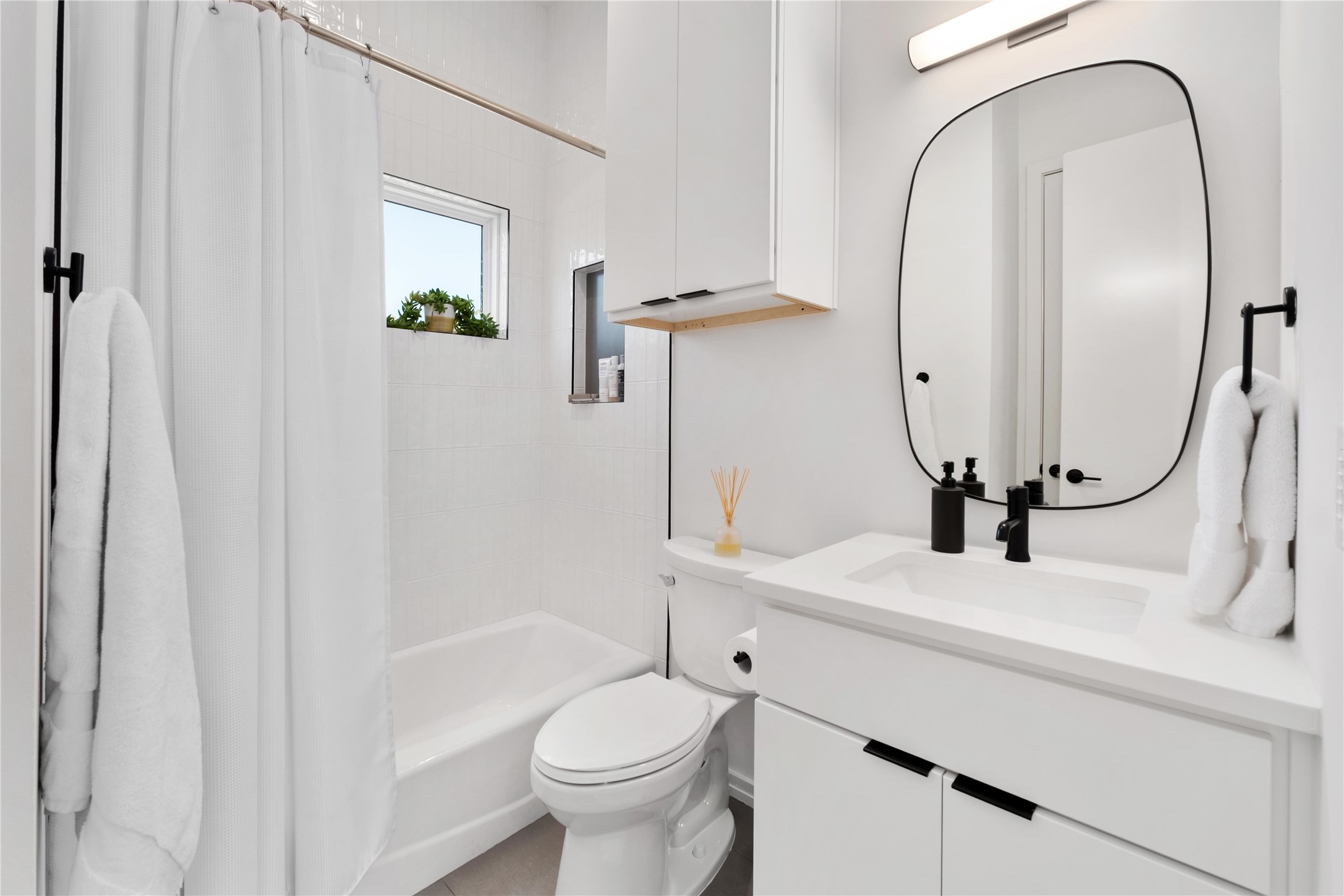 410 West Alpine Road, Unit 10 Austin, TX 78704 - Photo 21 of 31 a bathroom with a sink a toilet and a mirror