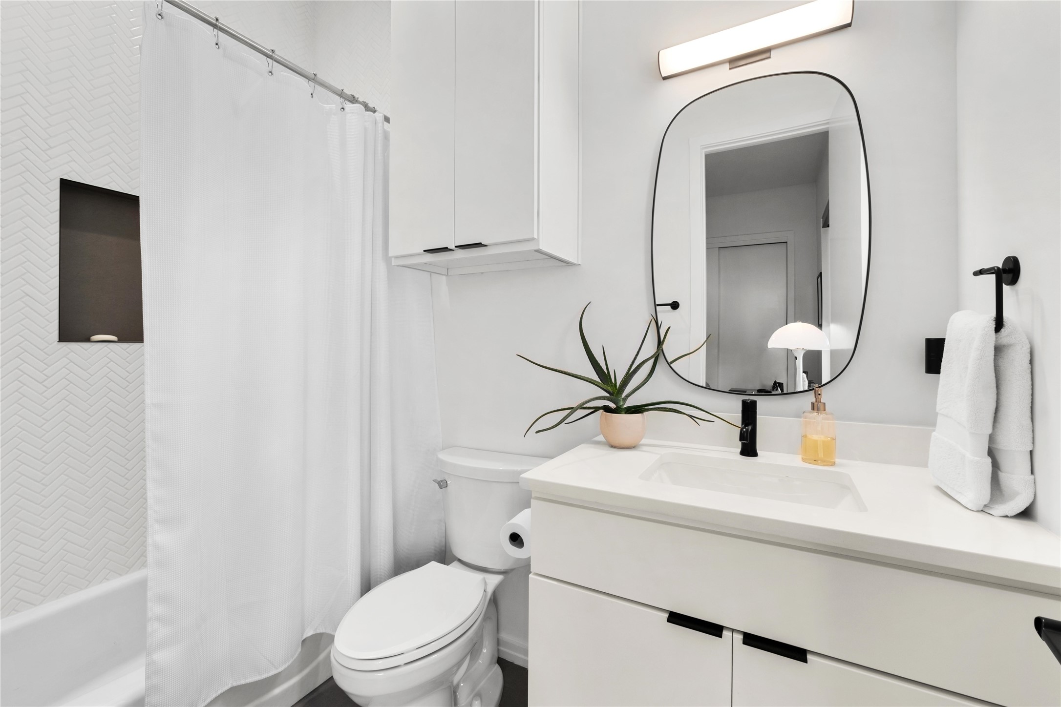 410 West Alpine Road, Unit 10 Austin, TX 78704 - Photo 23 of 31 a bathroom with a sink a toilet and mirror