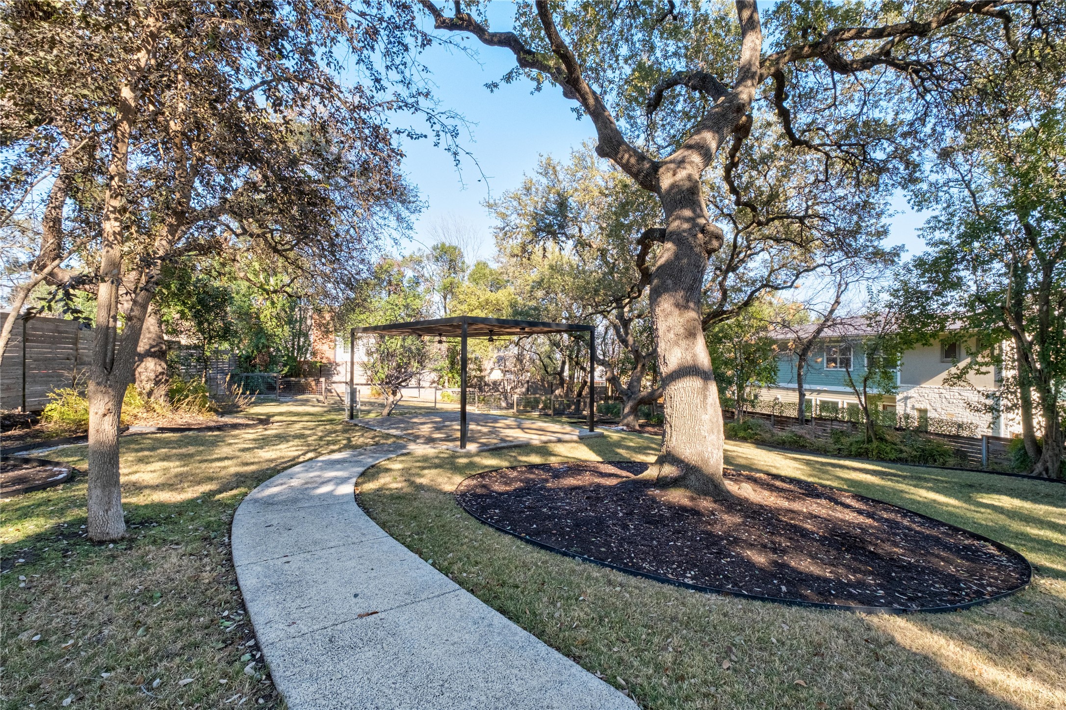 410 West Alpine Road, Unit 10 Austin, TX 78704 - Photo 28 of 31 a view of a yard with plants and trees