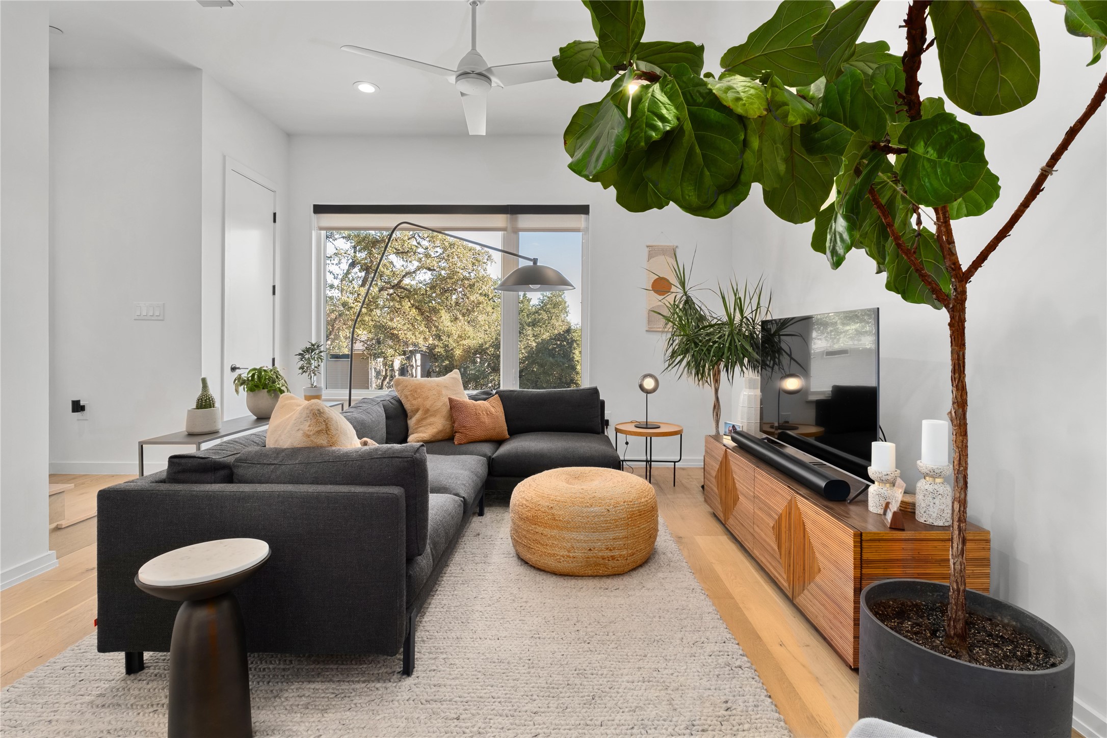 410 West Alpine Road, Unit 10 Austin, TX 78704 - Photo 6 of 31 a living room with furniture a chandelier and a flat screen tv