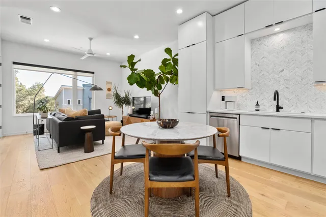 a living room with furniture a chandelier and a dining table