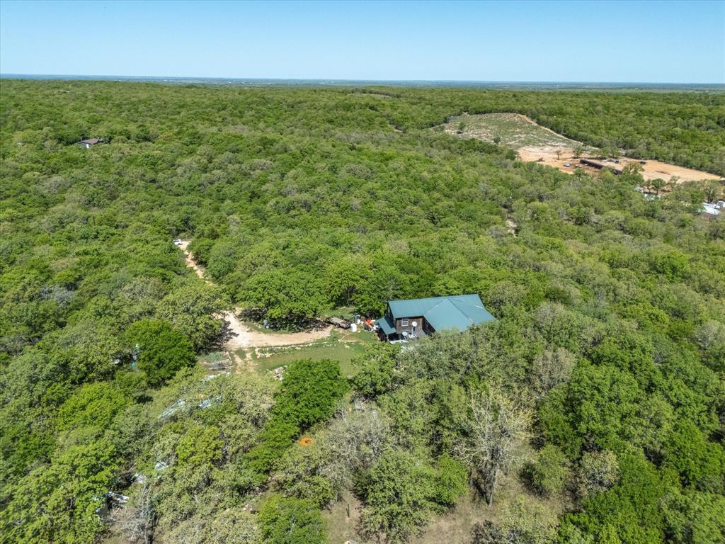 900 Old Spring Road Nocona, TX 76255 - Photo 16 of 27 an aerial view of residential houses with outdoor space and trees