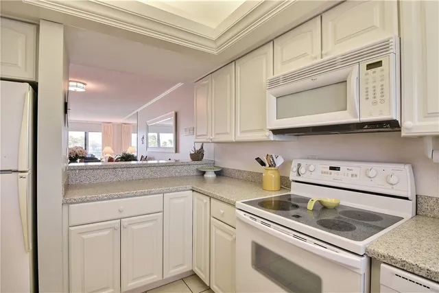 a kitchen with stainless steel appliances granite countertop a sink a stove and cabinets