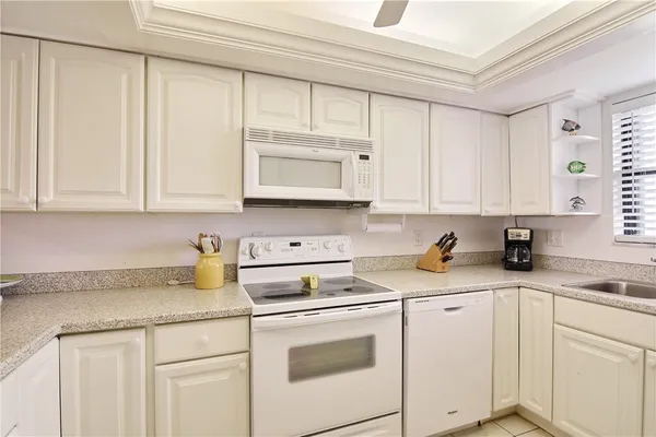 a kitchen with stainless steel appliances granite countertop a sink a stove and cabinets