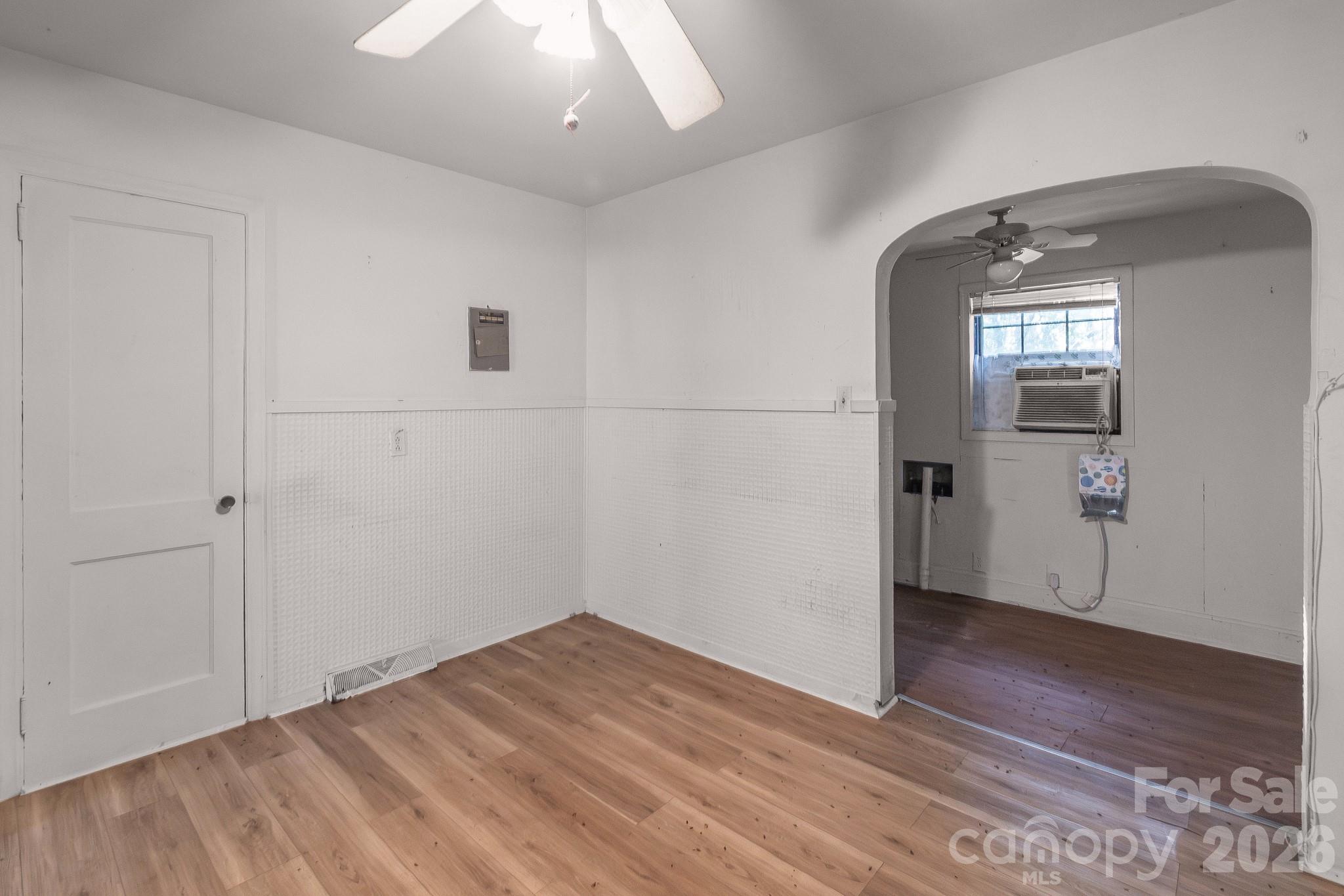 4430 West Tyvola Road Charlotte, NC 28208 - Photo 15 of 33 an empty room with wooden floor and windows
